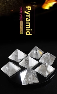 Macro detail of natural clear quartz pyramids with internal ice cracks on mirror base