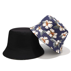 Minimalist black and navy floral print reversible cotton canvas bucket hats on white background