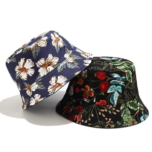 Detailed view of navy blue hibiscus and black berry print patterns on sun hats