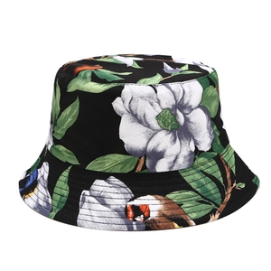 Detailed close-up of tropical floral and kingfisher bird pattern on black bucket hat