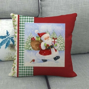 Federa per cuscino natalizio in lino con Babbo Natale su un divano grigio