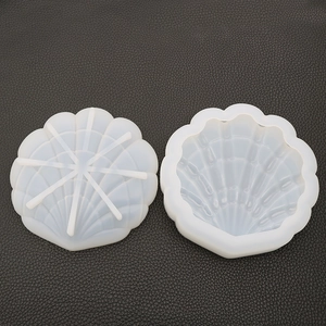 Detail of shell-shaped silicone molds showing translucent texture and fan-like ribs