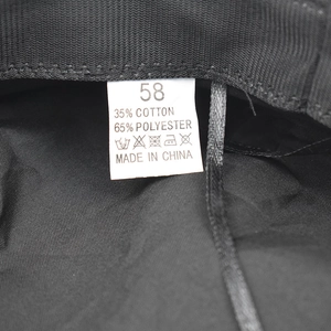 Detail of the internal size tag showing 58 and material blend on this black beret