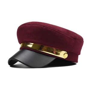 Classic burgundy wool newsboy cap with black faux leather brim and gold chain accent