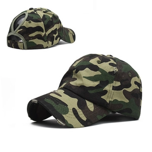 Detail of camouflage baseball cap featuring ponytail hole and distressed worn fabric