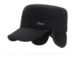 Detail view of winter wool cadet cap with ear flaps and silver Vashion metal logo