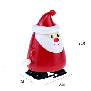 Close-up of wind-up Santa Claus toy with size dimensions 7x5x4cm on white background