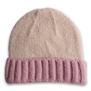 Détail d'un bonnet tricoté bicolore beige et rose avec tissu texturé doux
