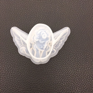 Macro shot of translucent white angel wings silicone mold for DIY resin and gypsum crafts