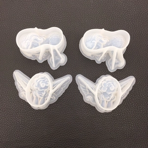 Detailed view of four translucent white silicone angel molds for DIY resin and plaster crafts