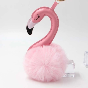 Detail of pink flamingo plush keychain with PU leather head and fluffy faux fur ball