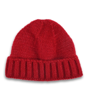 Detailed close-up of a red chunky knit beanie with classic ribbed texture and folded cuff