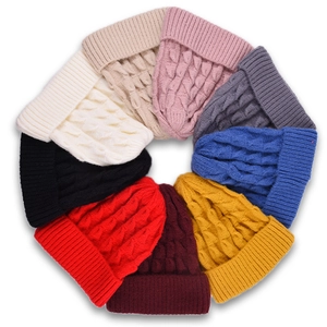 Classic knitted beanies in various colors arranged in a circle for autumn and winter