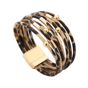 Detail of multi-layer leopard print wrap bracelet with golden metal tubes and magnetic clasp