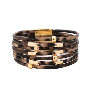 Detail of multi-layer wrap bracelet with leopard print leather and gold magnetic clasp