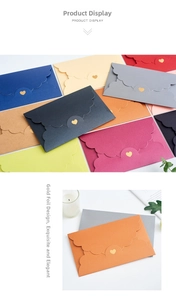Macro detail of wave-cut edges and gold foil heart on colorful pearlescent envelopes