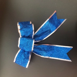 Sparkling royal blue Christmas bow with silver trim for tree decoration and gift wrapping