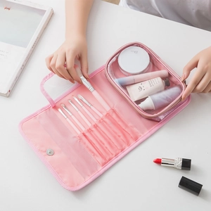 Pink portable PVC makeup brush organizer with multiple slots and a clear zipper pocket