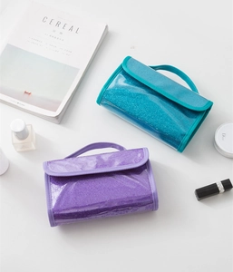 Detail of waterproof PVC glitter toiletry bags with hanging handles in blue and purple