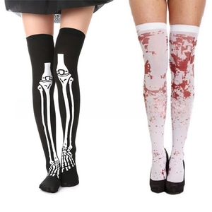 Detail view of Halloween over-knee socks featuring white bone and red blood patterns