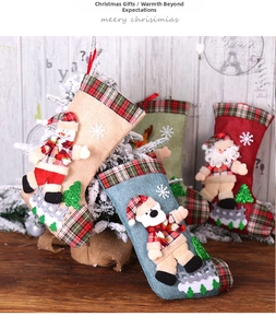 Close-up of burlap Christmas stockings with 3D snowman and Santa doll decorations