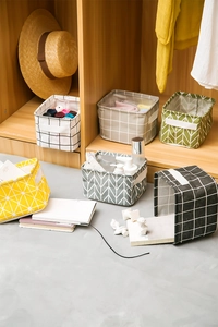 Close-up of foldable linen cotton storage baskets with various geometric patterns and handles