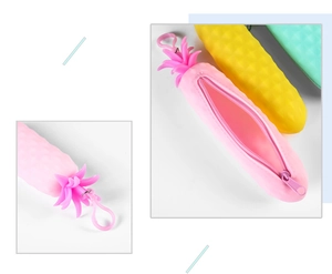 Detail of pink silicone pineapple pencil case showing zipper closure and leaf top hook