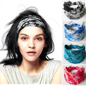 Macro detail of elastic tie-dye headbands in black, blue, and red for sports and yoga