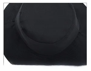 Macro shot of circular reinforced stitching on a black cotton bucket hat crown
