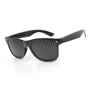 Black pinhole glasses for vision training and correction, 45-degree angle on white background