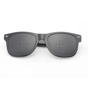 Detail of matte black pinhole glasses with metal rivets for vision correction training
