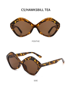Front and side view of trendy irregular hawksbill tea sunglasses with brown lenses