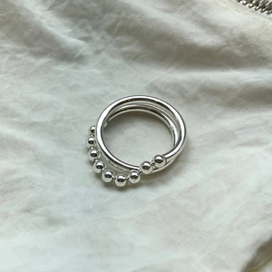 Detailed close-up of 925 sterling silver double-layered ring with beaded texture