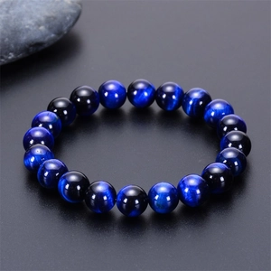 Macro shot of 10mm blue tiger eye beads showing natural chatoyancy and smooth polish