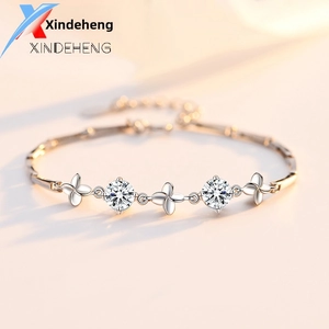 Macro shot of a 925 sterling silver bracelet with clover charms and brilliant round zircons