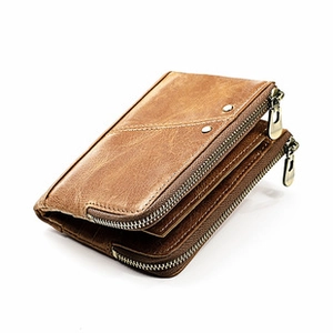 Detail view of brown leather RFID wallet showing dual zipper layers and rivet accents