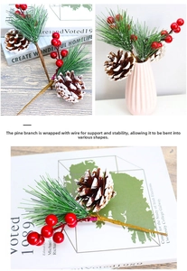 Close-up of artificial pine branch with red berries, pine cones and flexible wire