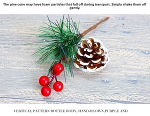 Macro detail of artificial pine branch with red berries and snow-dusted pine cone
