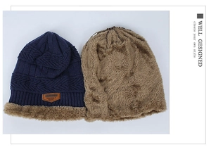 Detail of navy knit beanie showing thick brown fleece lining and decorative leather patch