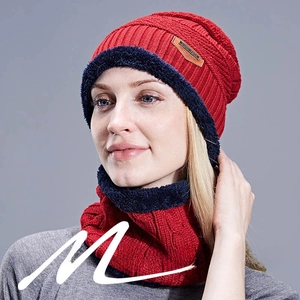 Close-up of thick knit beanie and neck warmer set with warm fleece lining and leather patch