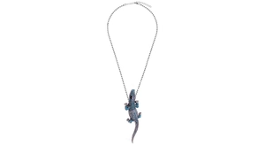Detailed view of crocodile pendant with blue and clear crystals on a silver ball chain