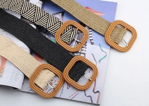 Detail of woven straw belts with large square buckles in four colors for summer dresses
