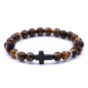 Detail of tiger eye stone beads bracelet featuring a black cross pendant and silver spacers