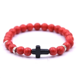Detailed macro of red turquoise beaded bracelet with black cross and silver accents
