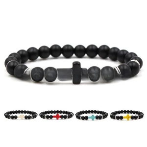 Detail of beaded cross bracelets showing matte black stones and various color accents