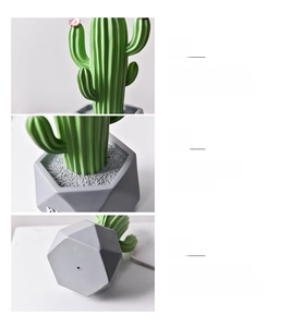 Detail of resin cactus ornament with pink flower and gray geometric pot decoration