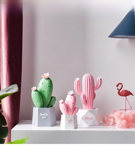 Close-up of Nordic decorative cacti ornaments with geometric pots and cute flower details