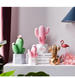 Pink and green Nordic resin cactus ornaments on Kinfolk books for room decor