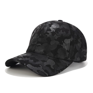 Detail view of the black camouflage pattern on a six-panel faux suede baseball cap