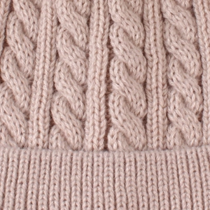 Detailed macro shot of baby knit hat featuring cable stitch patterns and ribbed edges